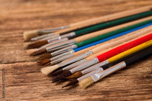 Collection of different paintbrushes on wooden board