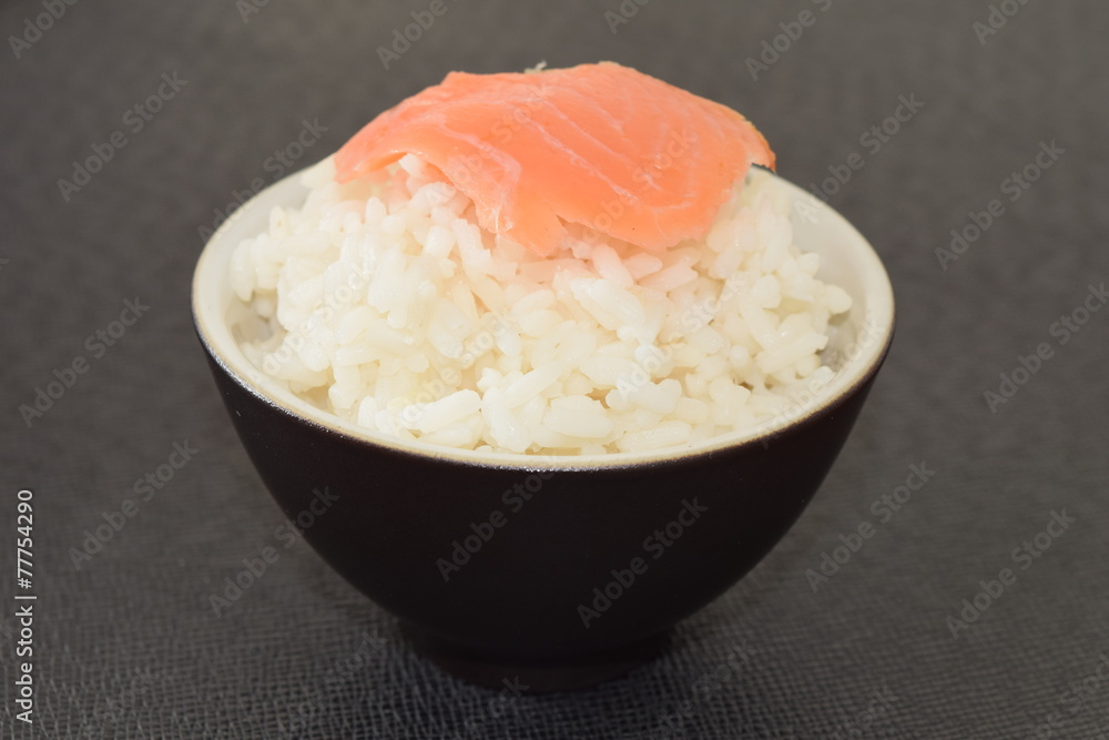 Sushi with salmon in a bowl on a black background. Sushi with salmon in a bowl on a black background.