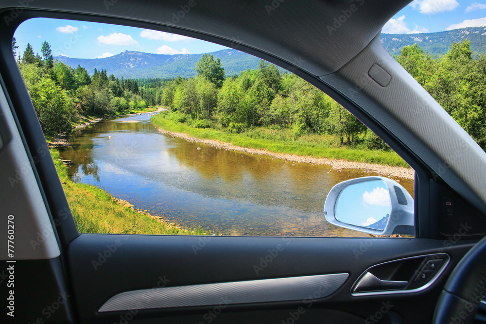 Naklejka premium landscape with river from car window