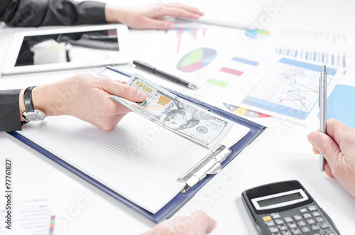 Business people exchanging dollar banknotes