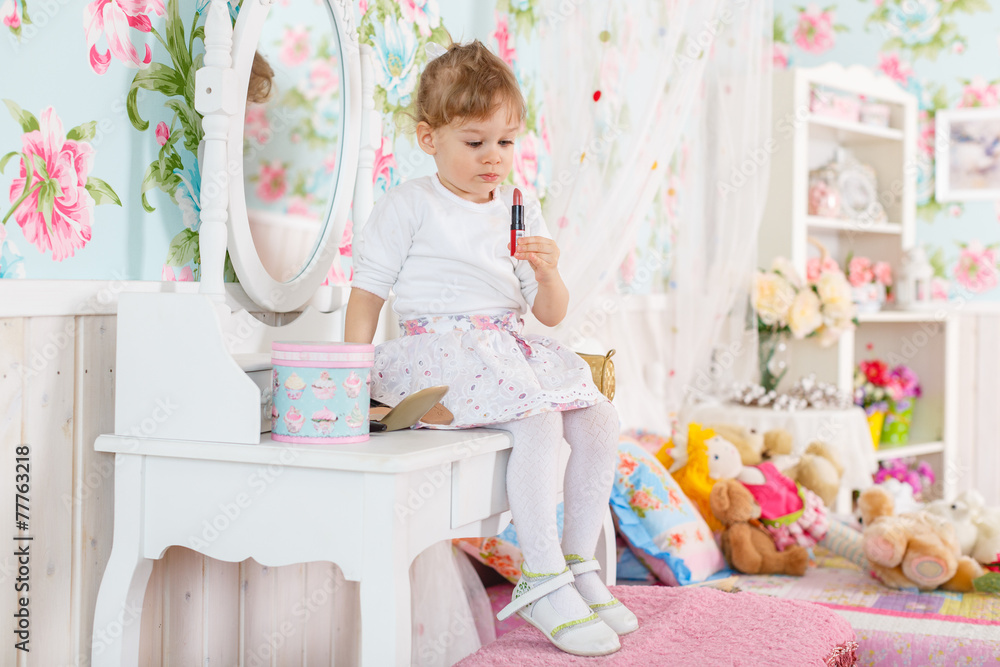 Little girl playing with cosmetics