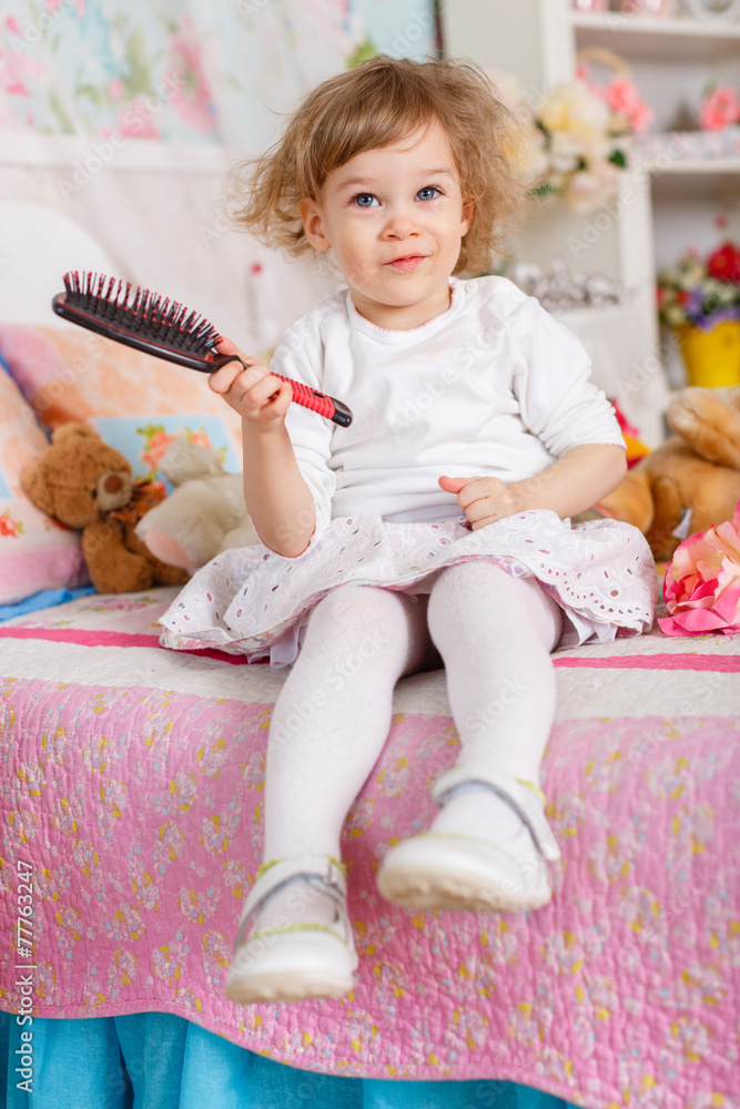 Fototapeta premium Little girl with hairbrush.