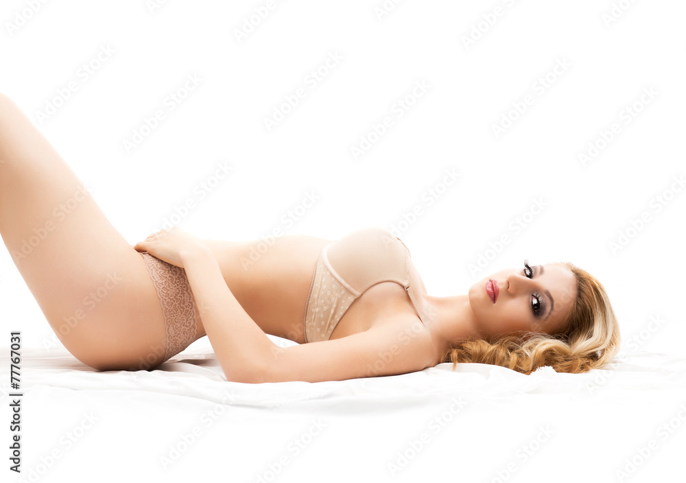 Fototapeta premium Young and beautiful woman in sexy underwear posing in the bed