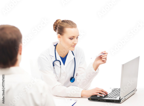 A female doctor with a laptop consulting a patient