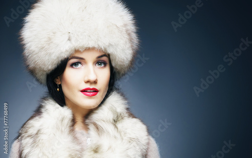 Fashion style portrait of a woman in an elegant winter clothes