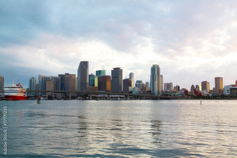 Miami city skyline with bridge and cruise ship at sunset