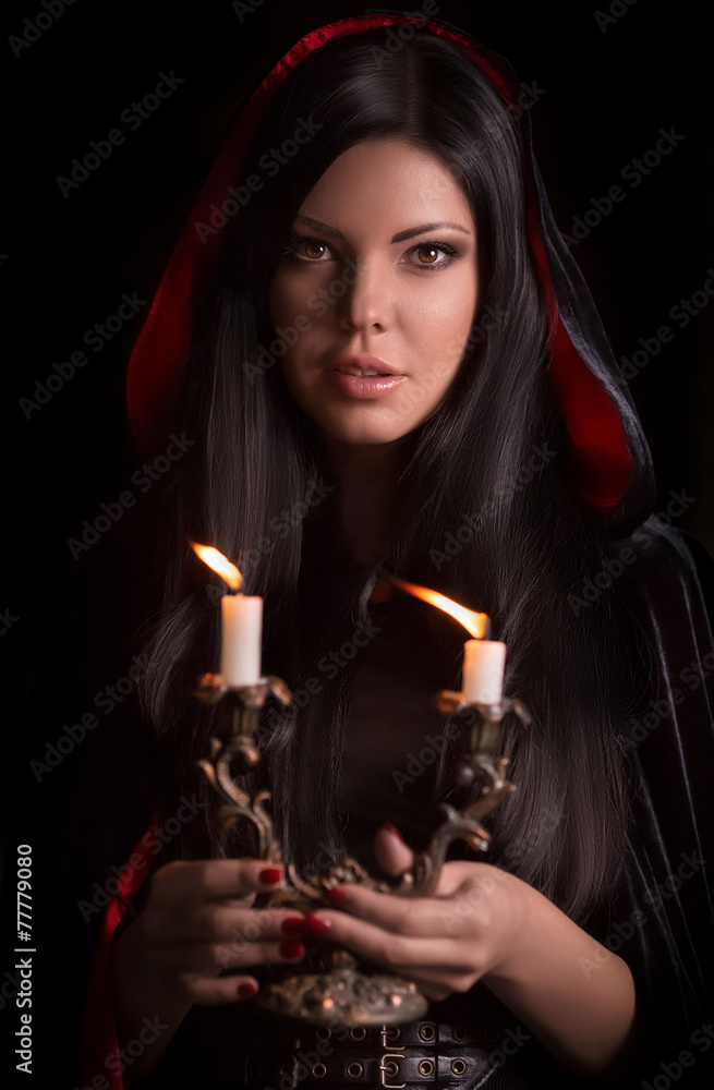 Beautiful woman with black cloak over black background Beautiful woman with black cloak over black background
