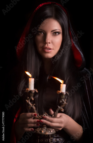 Beautiful woman with black cloak over black background © Forewer