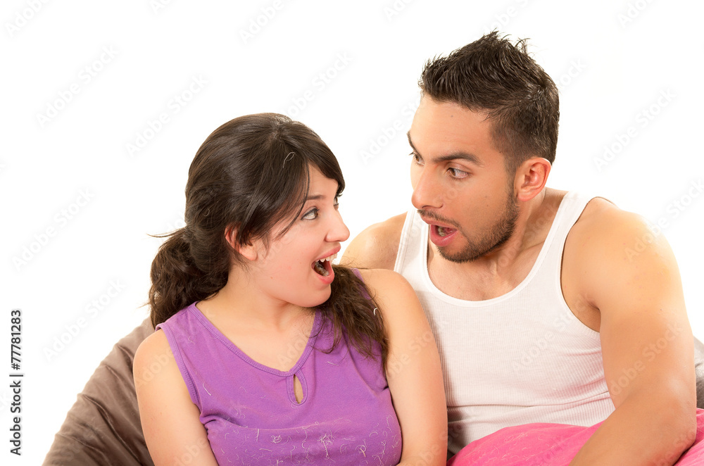 sweet latin couple looking at each other surprised wearing their sweet latin couple looking at each other surprised wearing their