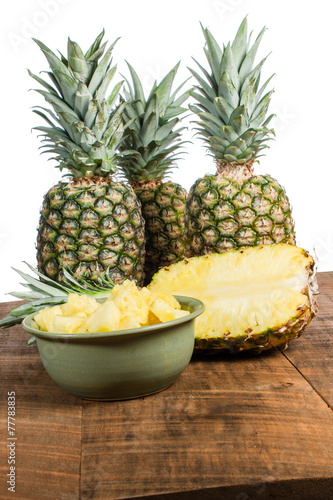 Pineapples and bowl of cut fruit