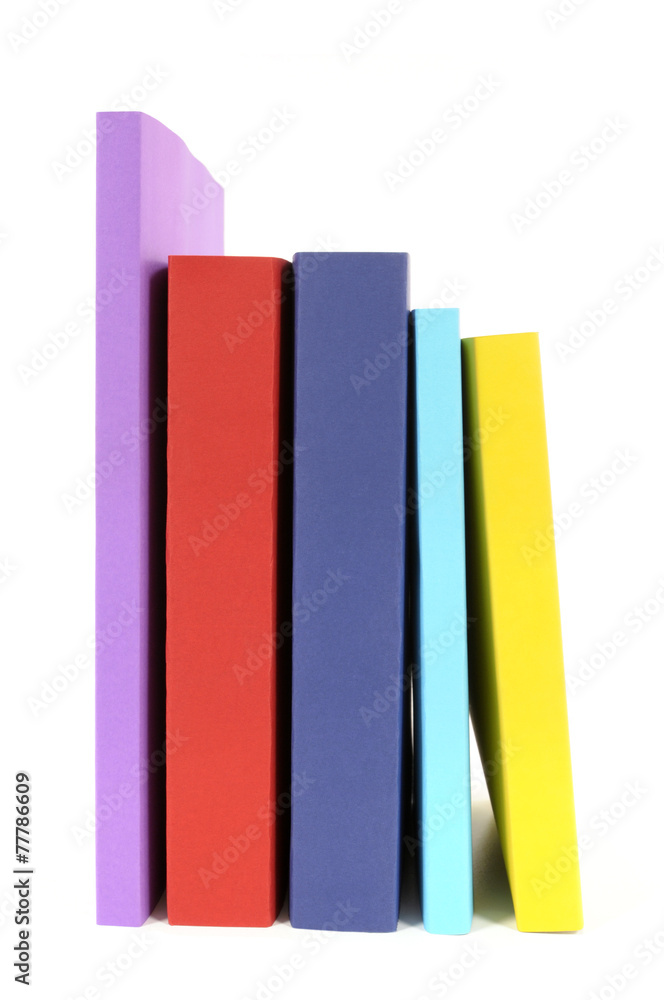 Naklejka premium Collection of colorful paperback books in a row line isolated white background photo
