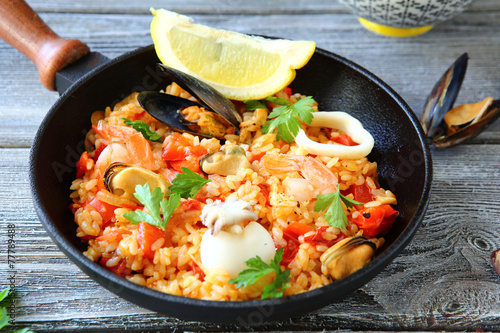 Paella with rice and seafood in a frying pan