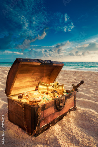Open treasure chest on the beach