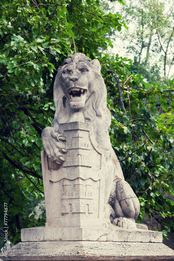 Stone lion with a board in paws  in Budapest
