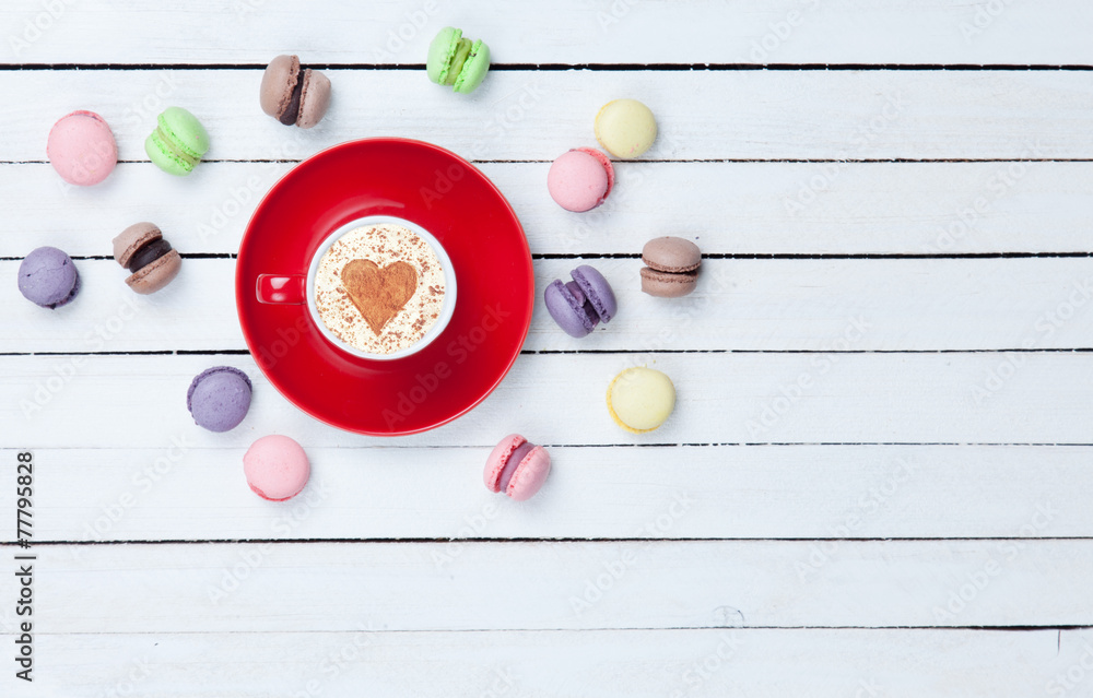 Cappuccino with heart shape symbol and macaron Cappuccino with heart shape symbol and macaron