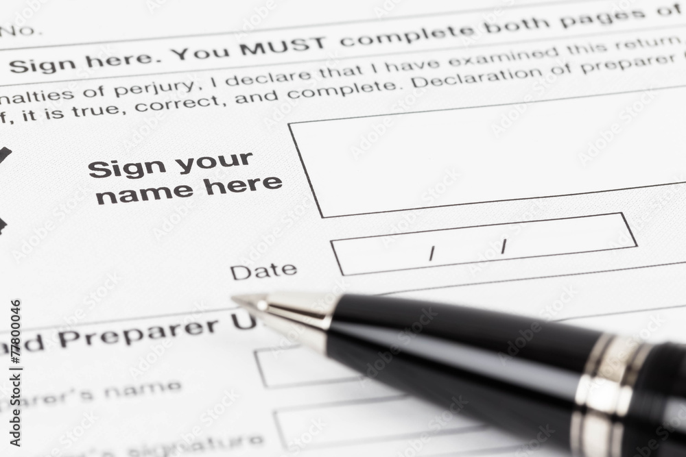 Tax form signature space with pen taxation concept Tax form signature space with pen taxation concept