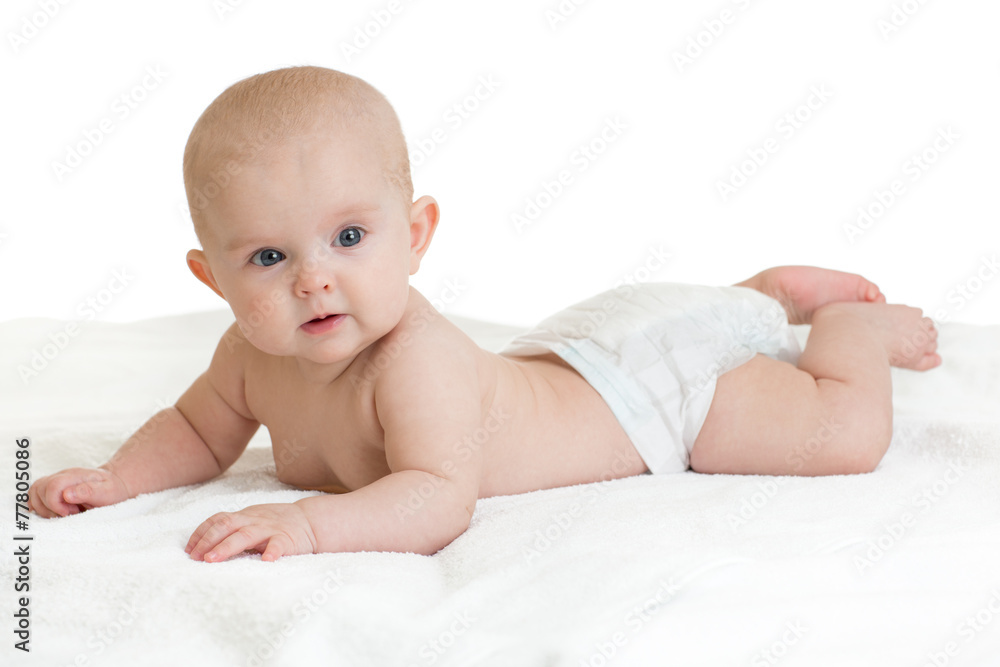 Cute baby lying on white towel in nappy or diaper Cute baby lying on white towel in nappy or diaper