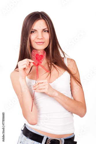 Young woman holding a red heart