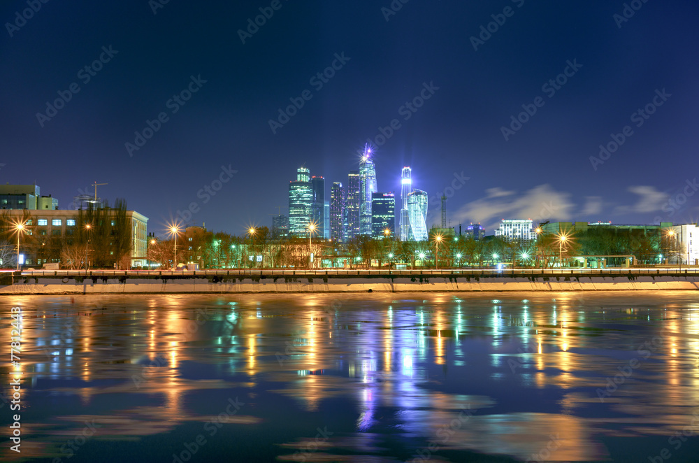 Moscow city skyscrapers in the winter night from the river.