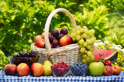 Fototapeta Naklejka Na Ścianę i Meble -  Basket of fresh organic fruits in the garden
