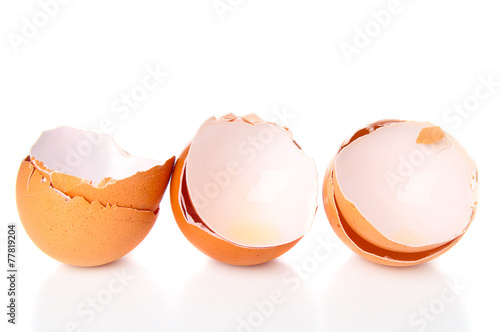 Cracked eggshells on white background