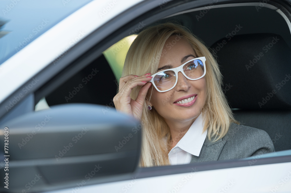 Mature business woman in a car