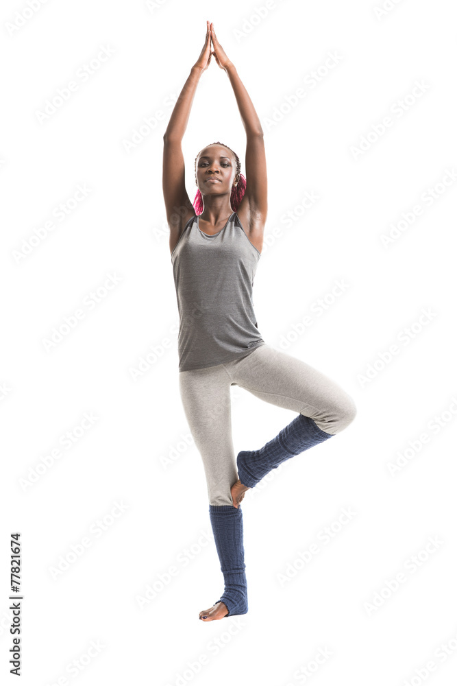 Young african woman in the tree yoga position Young african woman in the tree yoga position
