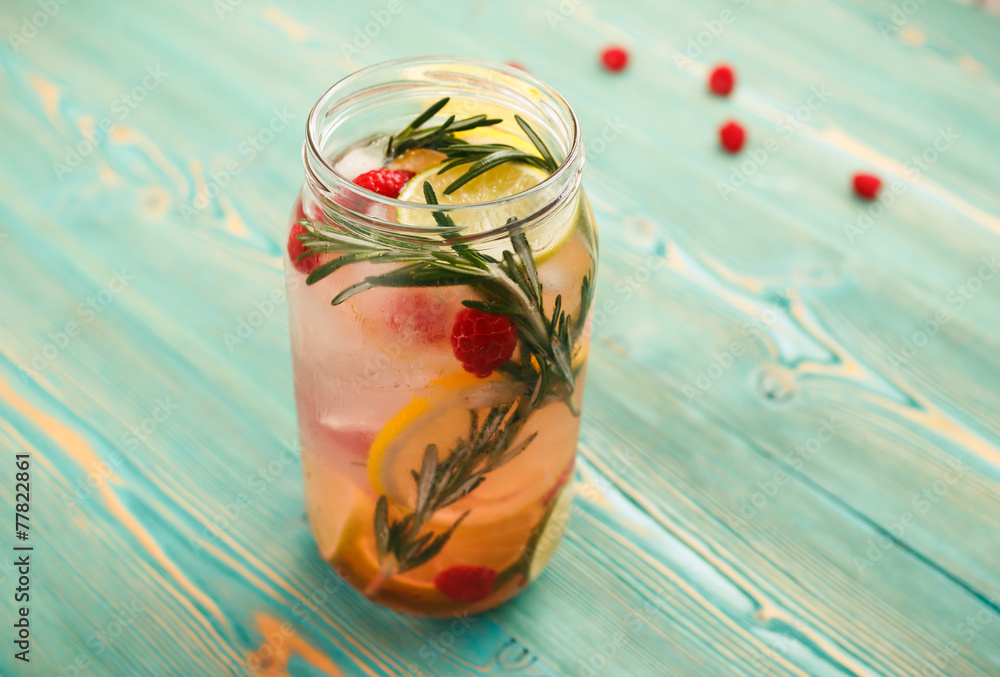 Detox water with citrus, raspberry and rosemary in jar