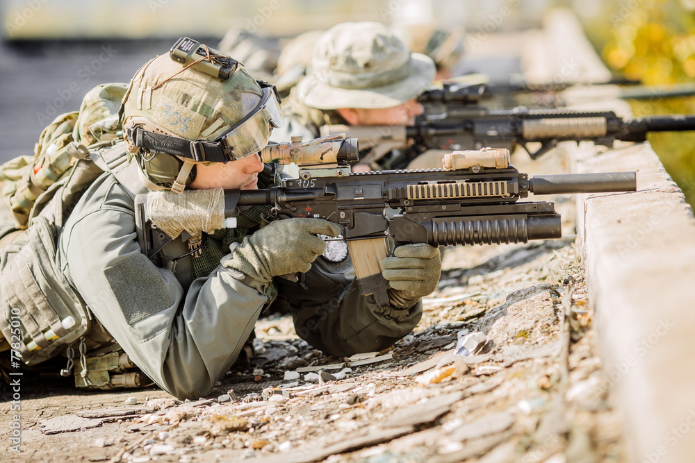 group of soldiers lie and shoot group of soldiers lie and shoot