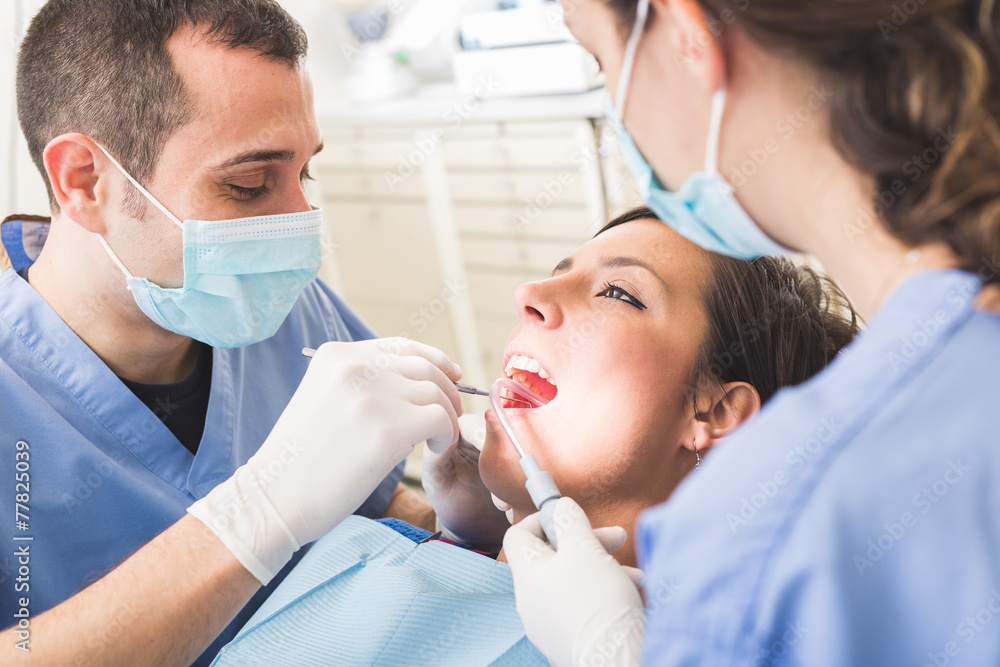 Dentist and Dental Assistant examining Patient teeth. - obrazy, fototapety, plakaty 