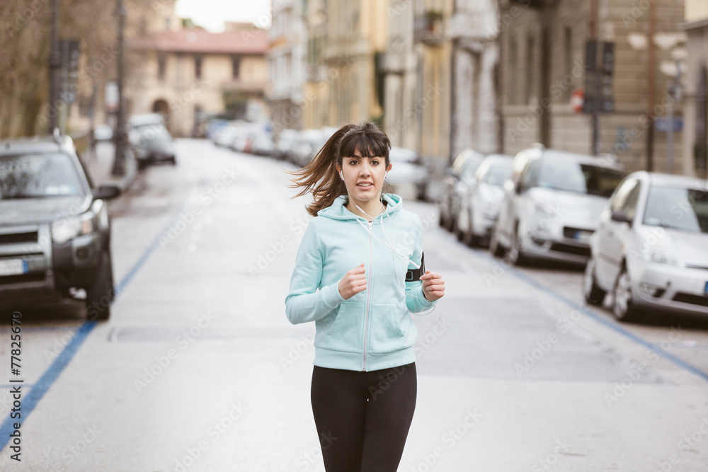 Beautiful Young Woman Jogging Alone on City  Street