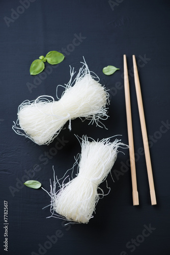 Raw chinese crystal noodles over black wooden background