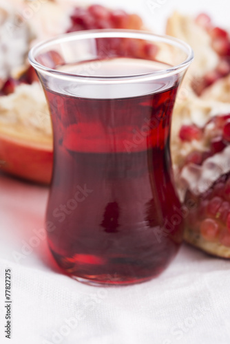 Ripe pomegranates with juice on table
