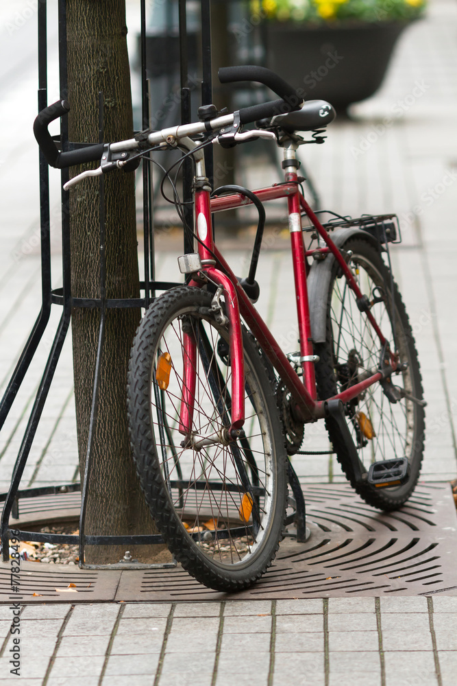 Red bicycle parked on the street in Vilnius Red bicycle parked on the street in Vilnius