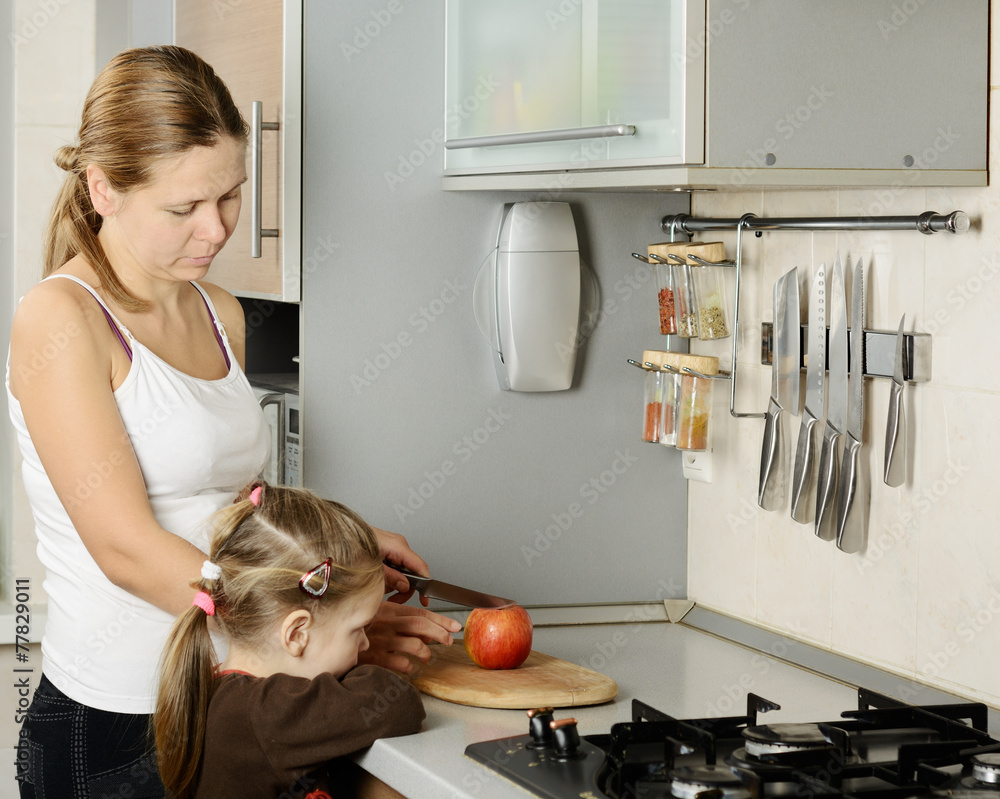 Mother and her daughter in the kitchen