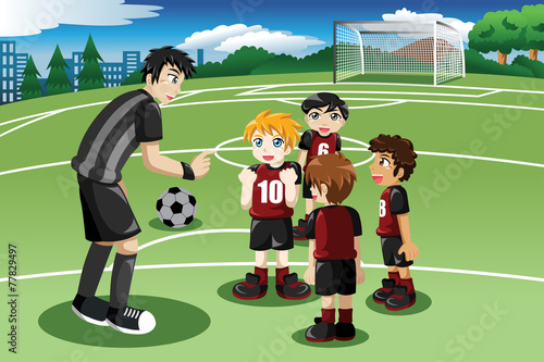 Little kids in soccer field listening to their coach