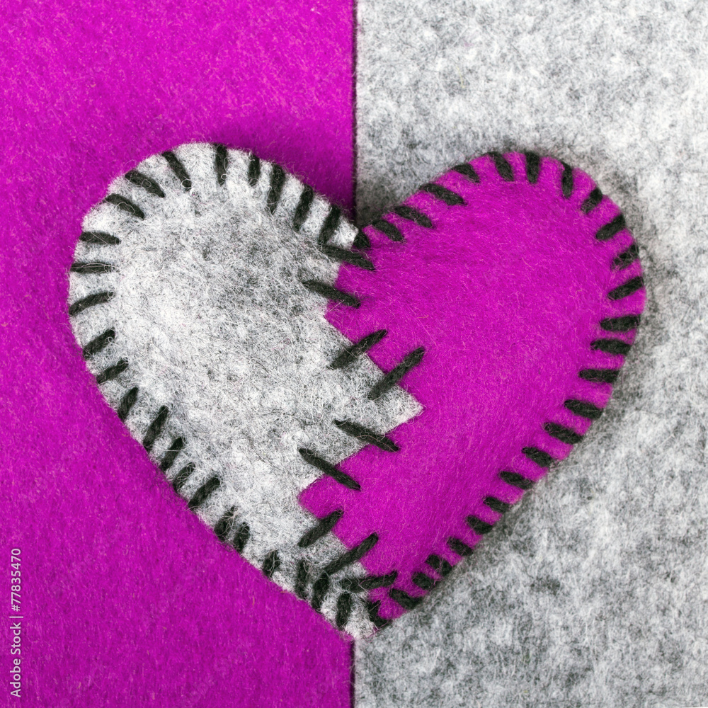 stitched broken felt heart on a on a two-color background
