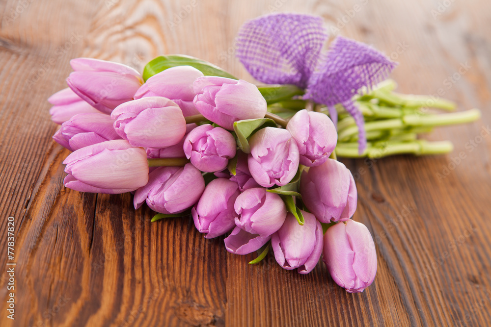 Pink tulips on wooden planks