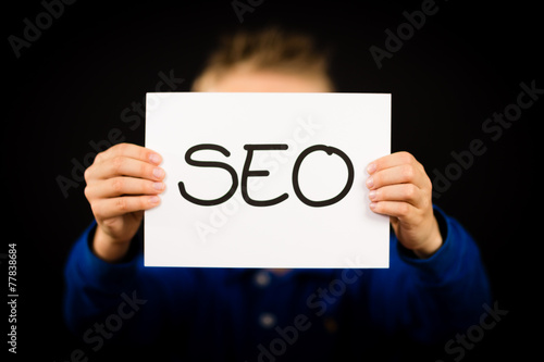 Person holding SEO sign