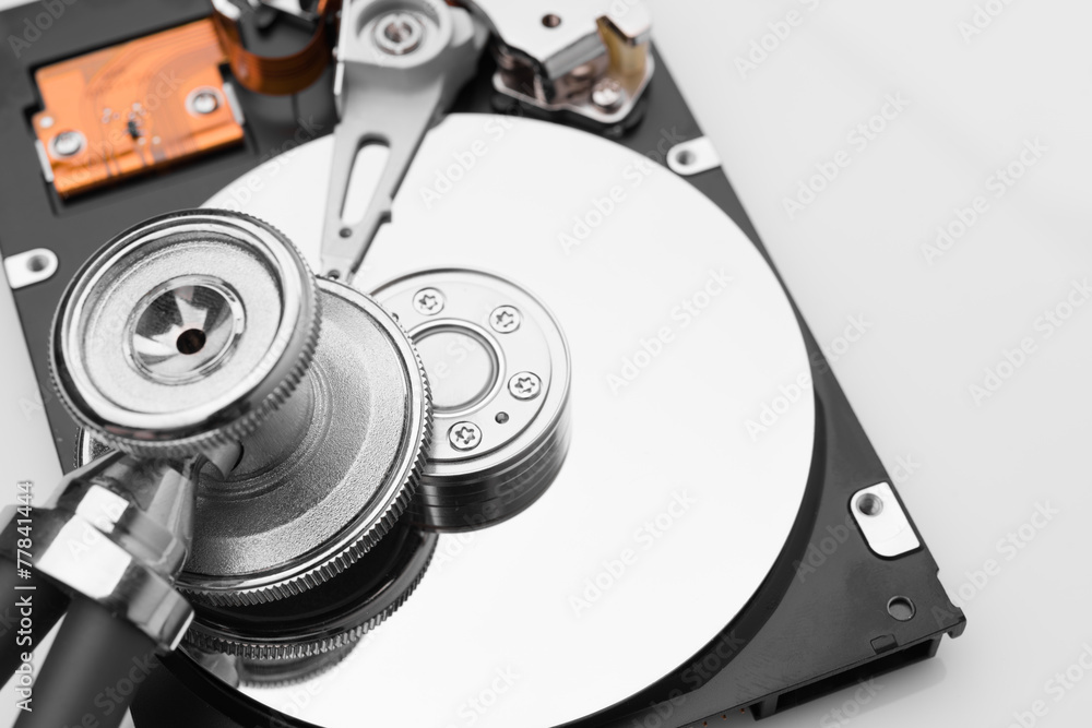 stethoscope on the hard disk drive over white stethoscope on the hard disk drive over white