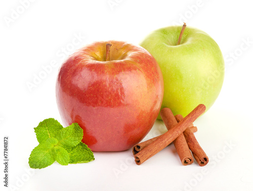 Ripe apple with cinnamon sticks