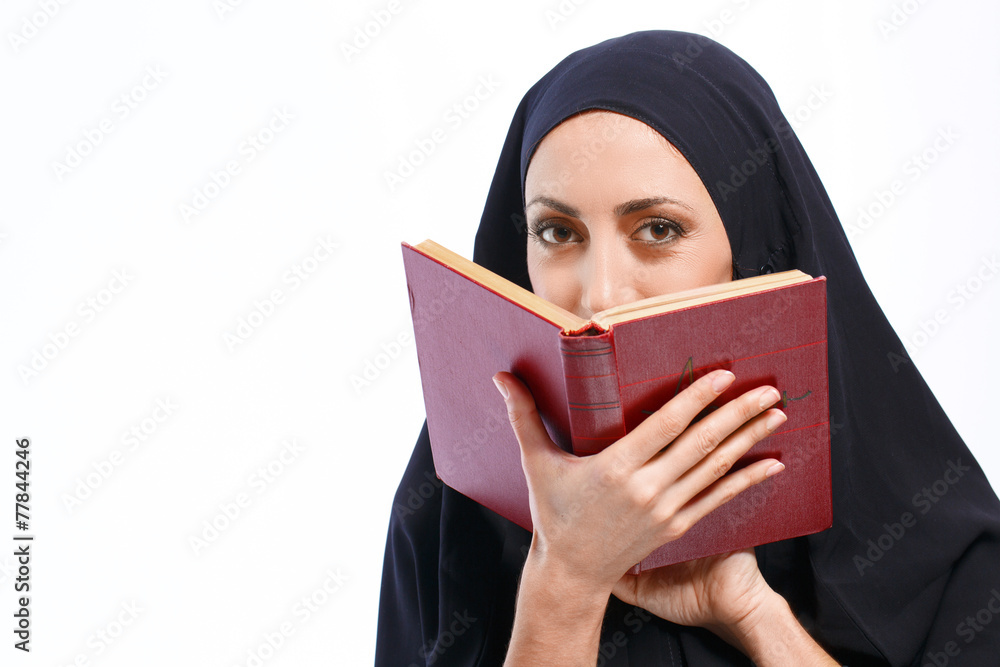 Fototapeta premium Beautiful Muslim woman holding a book