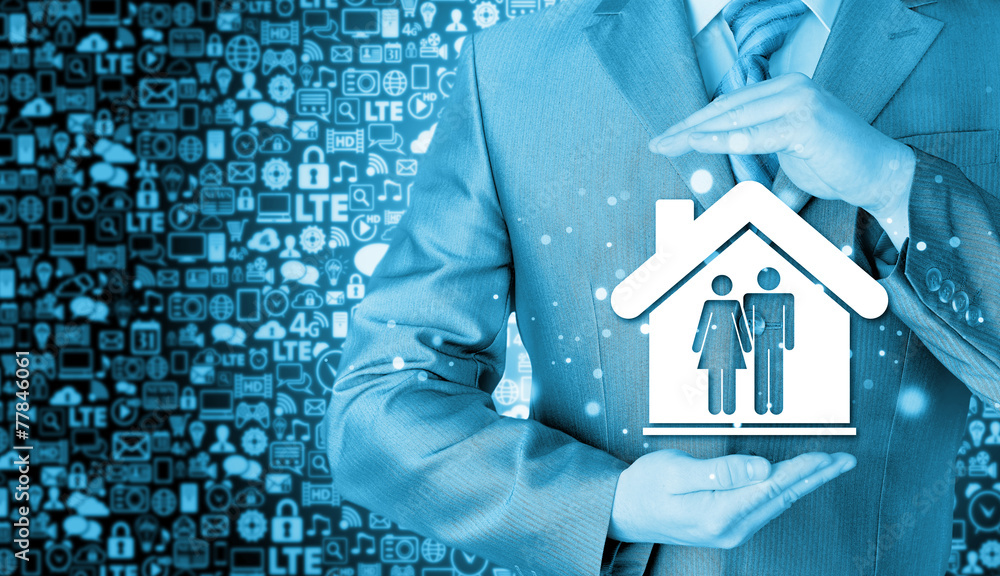businessman protecting family in home with hands businessman protecting family in home with hands