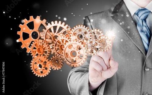 businessman hand touch  gear to success concept