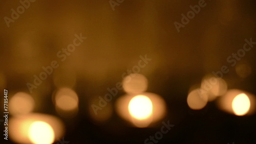 Bokeh blur defocused background of tea light candles glittering