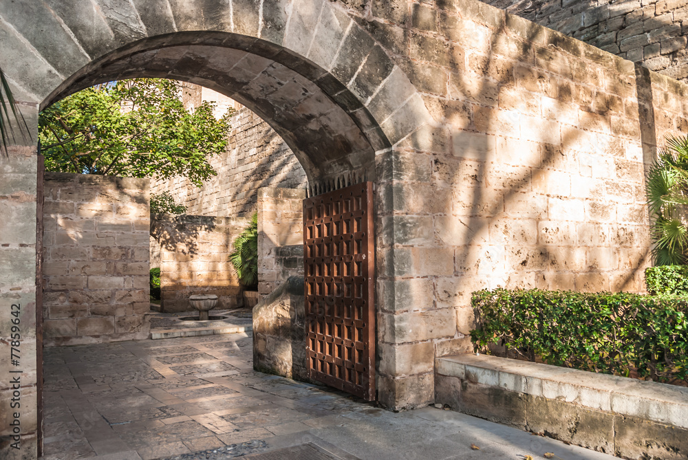 Arched entrance with a wooden gate in Palma de Majorca Arched entrance with a wooden gate in Palma de Majorca