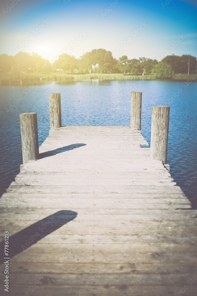 Naklejka premium Old Wooden Deck with Lake in Background