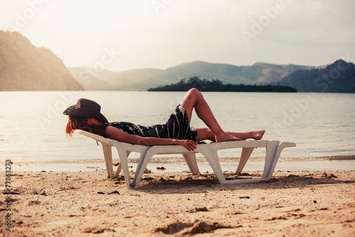 Obraz na plátne Woman relaxing on sunbed in the tropics