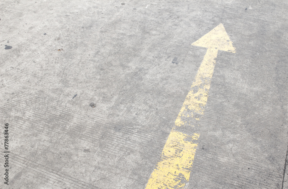 yellow way arrow pointing in directions symbol on a ground road yellow way arrow pointing in directions symbol on a ground road