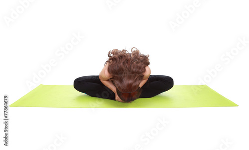 Young woman doing yoga exercise with yoga mat photo